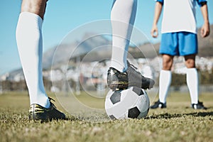 Soccer, legs and foot on ball for match, game or start on the green grass field in nature outdoors. Feet of sports