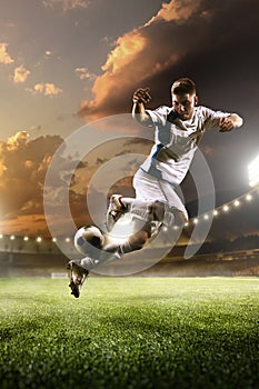 Soccer player in action on sunset stadium background