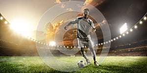 Soccer player in action on sunset stadium panorama background