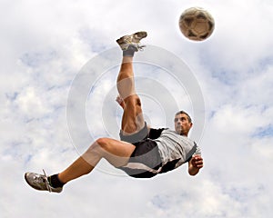 Soccer player in a bicycle kick photo