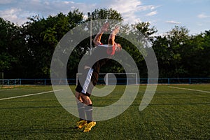 Soccer player celebrating goal on a soccer stadium.Soccer player does a backflip