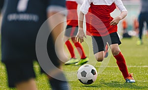 Soccer Player Dribbling, Young Footballer in Run with Ball. Boys Kicking Sports Soccer Game on Sunny Summer Day