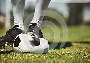 Soccer player feet, deflated soccer ball and sports, competition game and training on grass field, pitch and lawn