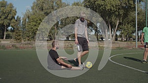 Soccer player helping teammate to get up after foul