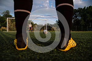 Soccer player hits the ball. Football player kicking penalty