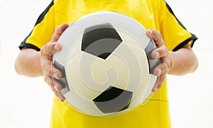 Soccer player holding a football.