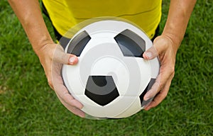 Soccer player holding a football.