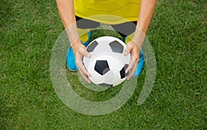 Soccer player holding a football.