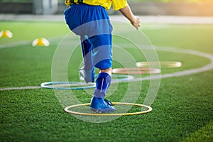 Soccer player Jogging on green artificial turf and stretching their feet. warming up the body and foot