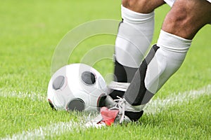 Soccer player kicking ball photo