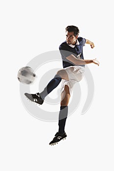 Soccer player kicking a soccer ball