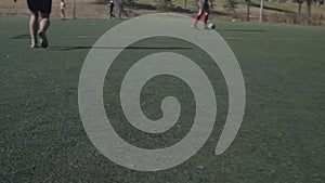 Soccer player legs dribbling during football game