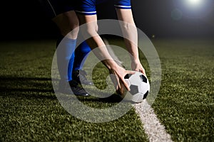 Soccer player placing the football on center line