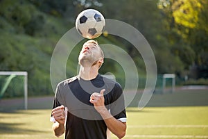 Soccer player playing with ball on field