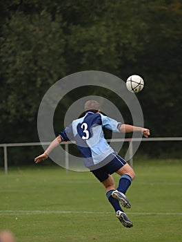 A soccer player playing football