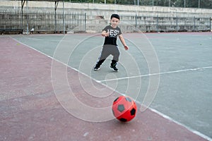 Soccer player running after the ball.