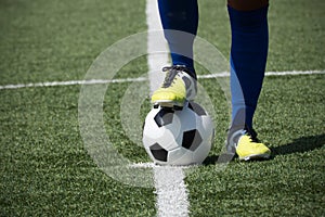 Soccer player's feet on the ball