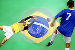 Soccer player scoring goal in front of Brazilian Flag