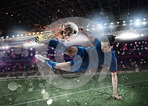 Soccer player with soccerball on fire at the stadium during the match.