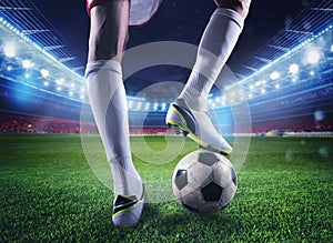 Soccer player with soccerball at the stadium ready for the match