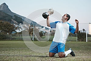 Soccer player, sports and man celebrate trophy on field for competition game outdoor. Black male athlete champion