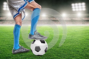 Soccer Player Standing Over Football in Outdoor Stadium With Copy Space