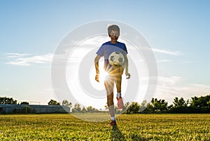 Soccer player kicks ball in a field