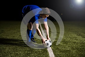 Soccer player about to kick the football
