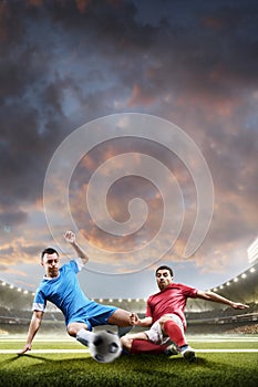 Soccer players in action on sunset stadium background