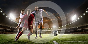 Soccer players in action on sunset stadium background panorama