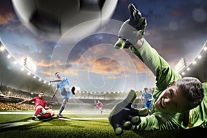 Soccer players in action on sunset stadium background panorama