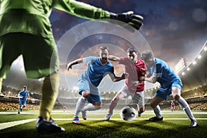 Soccer players in action on sunset stadium background panorama