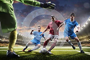 Soccer players in action on sunset stadium background panorama