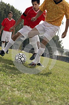 Soccer players competing for ball