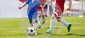 Soccer Players in a Duel. Elementary Age Kids in Soccer Clubs of Soccer Academies photo