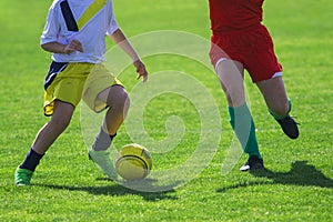Soccer Players in a Duel on Grass Running After Soccer ball