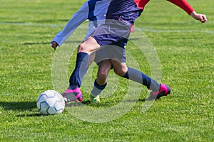 Soccer Players in a Duel on Grass Running After Soccer ball