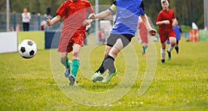Soccer players duel. Soccer youth tournament game. Footballers compete for a soccer ball