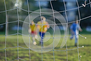 Soccer players in front of net