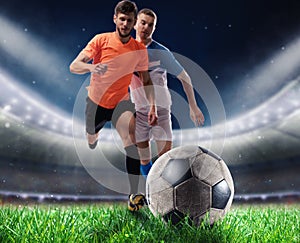 Soccer players play with soccerbal at the stadium