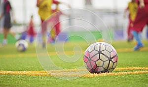 Soccer players running in grass field in match