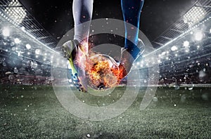 Soccer players with soccerball on fire at the stadium during the match
