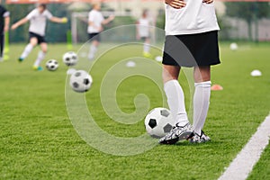 Soccer Players on Training Pitch. Group of Footballers Kicking Soccer Balls on Practice Unit