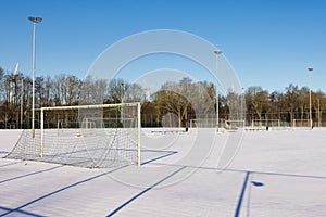 Soccer playing field with goals covered with white snow