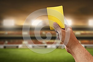 Soccer referee hand hold yellow card