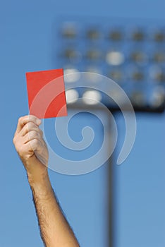 Soccer referee hand holding red card