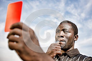 Soccer Referee Holding Out a Red Card