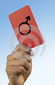 Soccer referee holding up red card close-up on hand