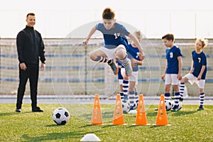 Soccer school training unit. Football boys in team on practice session with youth coach