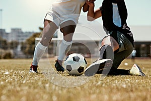 Soccer, sports and athletes playing with a ball on an outdoor field for a match or training. Fitness, men and closeup of